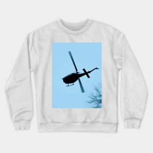 A Bell UH-1 Huey Iroquois flying low over trees Crewneck Sweatshirt